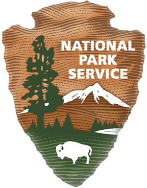 An orange arrowhead with a mountain and white bison in the background with text National Park Service.